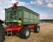 while harvesting a female farmer climbing at the trailer on a what field